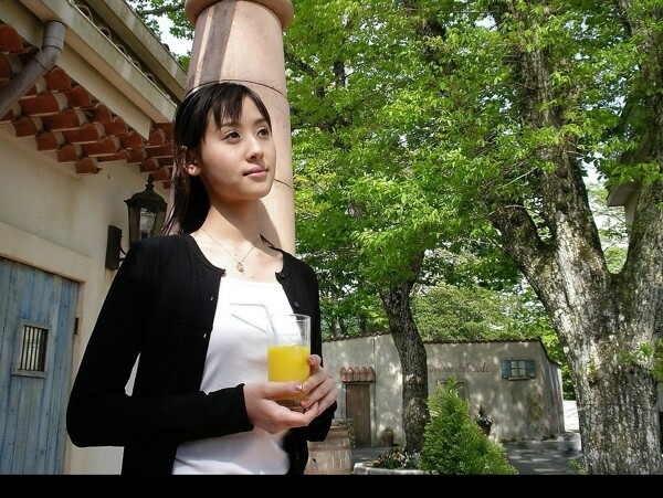漂亮女人庭院里喝果汁图片